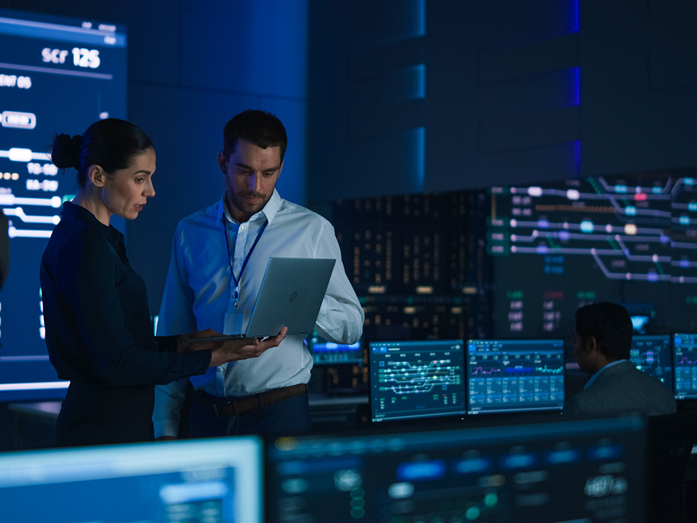 man and woman working together in a high tech data centre