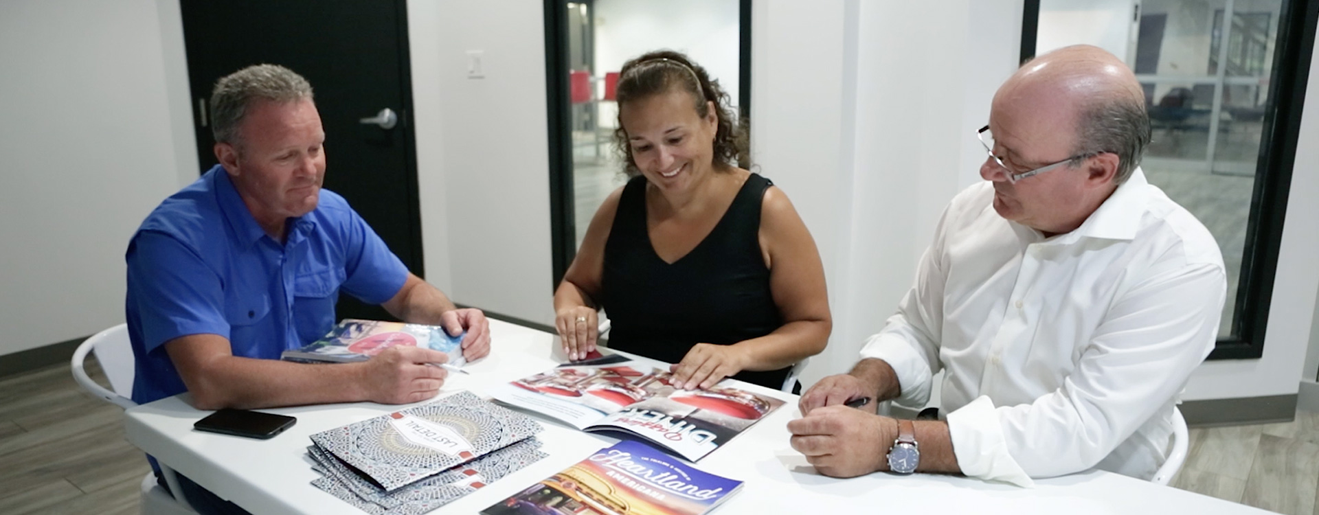 Employees sitting and reviewing booklet