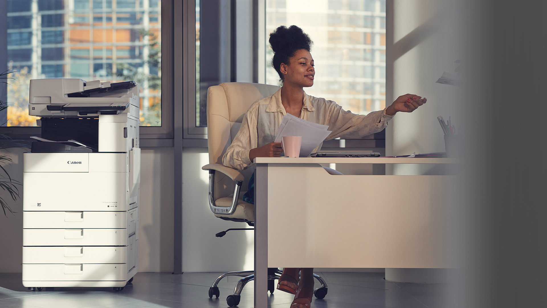 Woman working in office, Canon printer to her side