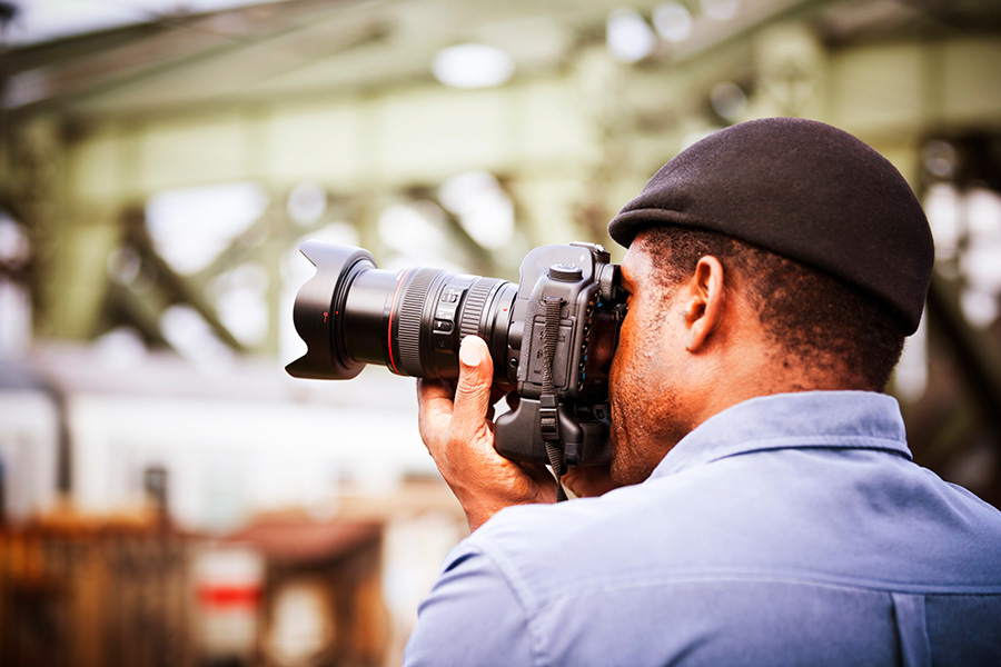 man shooting with a Canon camera
